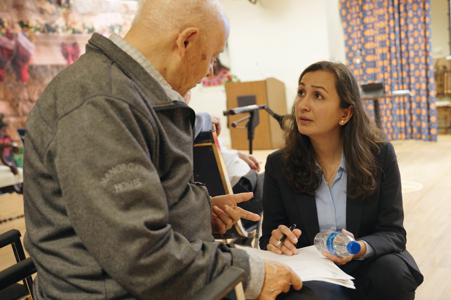 Universal Health Hub team member talking with a senior patient